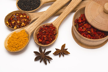 Spice. Spice in a wooden spoon. Herbs. Curry, saffron, turmeric, pepper and other isolated on white background.