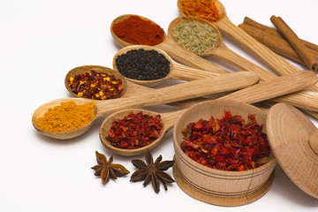 Spice. Spice in a wooden spoon. Herbs. Curry, saffron, turmeric, pepper and other isolated on white background.