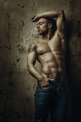 Young muscular and sexy man with tattoos posing in different poses