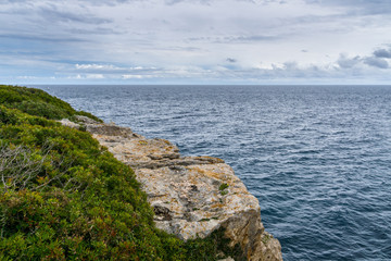 Mallorca, Stormy rainy weather at rough cliff line near town Portocolom