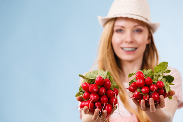 Happy woman holding radish