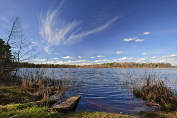 A beautiful cirrus cloud over the forest lake. Nature landscape. Novgorod region, Russia. - 207508161
