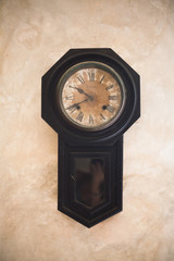 precioso reloj antiguo sobre pared con textura color ocre