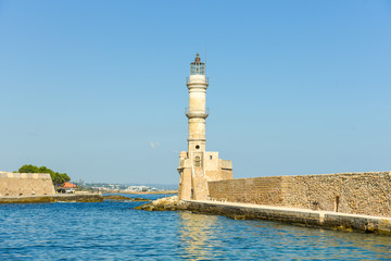 Fototapeta premium Lighthouse in the historical venetian port of Chania. The greek city on the north coast of Crete is one of the most beautiful towns on the island 