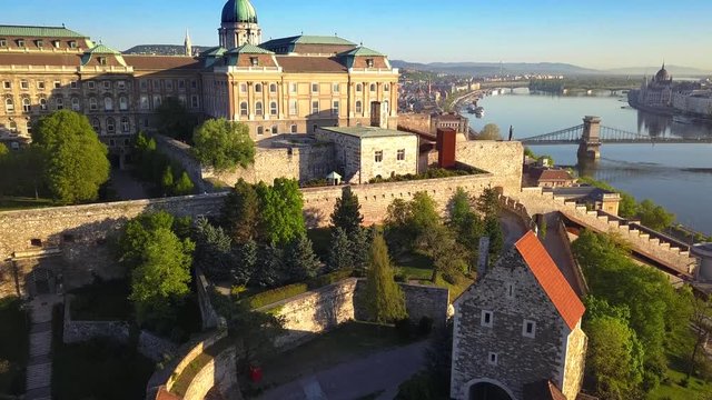 Budapest, Hungary - Flying up at Buda Castle Royal Palace and South Rondella with Szechenyi Chain Bridge and Parliament at background