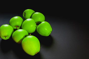 green apples on black background