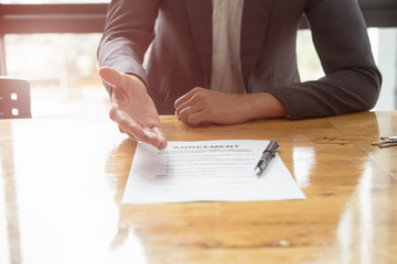 real estate agent holding house key to his client after signing contract,concept for real estate, moving home or renting property