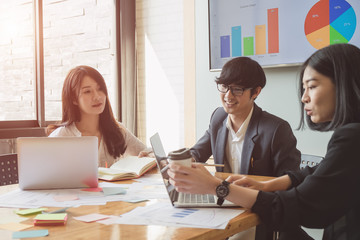 Asian business people meeting with new startup project pointing graph discussion and analysis data charts and graphs.Business finances and accounting concept