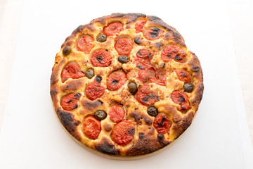 Focaccia typical of Bari Italy with tomatoes and olive