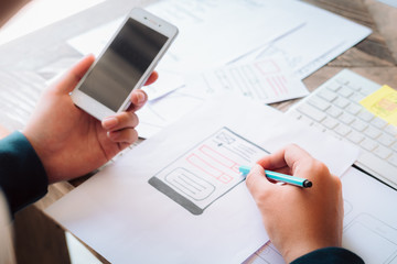 Fototapeta na wymiar Web designer planning application for mobile phone. Design Online Technology Content, Ideas Proposal Strategy Tactics Vision Design Concept