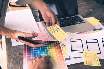 Web designer meeting  planning application for mobile phone. Design Online Technology Content,...