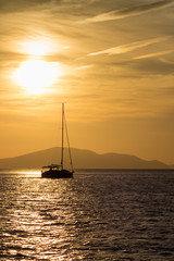 Boat and Greek Island at sun set