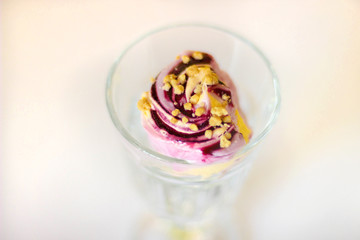 Sweet blueberry and melon icecream in the glass on the white background