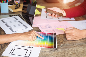 Web designer meeting  planning application for mobile phone. Design Online Technology Content, Ideas Proposal Strategy Tactics Vision Design Concept