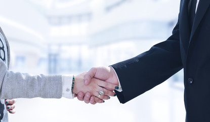 Businessman and businesswoman shaking hands after meetup