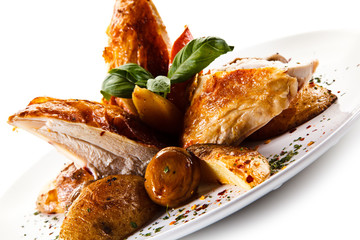Grilled chicken breast with baked potatoes white background