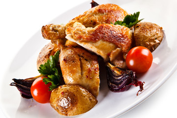 Grilled drumsticks with baked potatoes white background