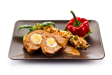 Meatballs stuffed with boiled eggs with vegetables