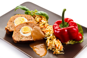 Meatballs stuffed with boiled eggs with vegetables