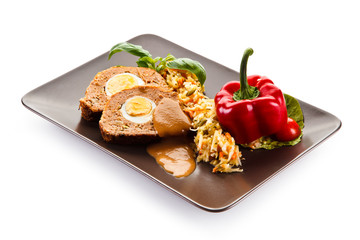 Meatballs stuffed with boiled eggs with vegetables