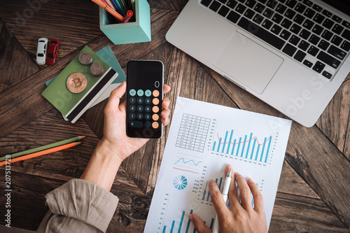 asian man working with calculator to calculate numbers expenses