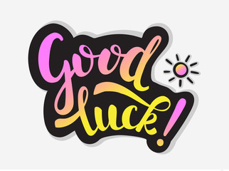 Good Luck inscription and small sun. Colorful handwritten text with Black black outline on grey background. For stickers, cards, posters, flyers