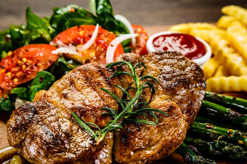 Grilled steak with french fries and vegetables