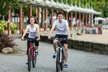 Healthy lifestyle - people riding bicycles in city park