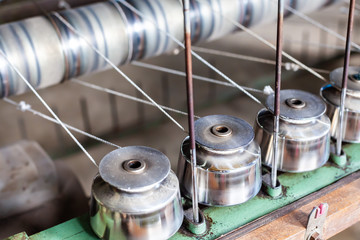 Close Up Textile Industry Yarn Spools on Spinning Machine in a Factory. Yarn spinning machine....