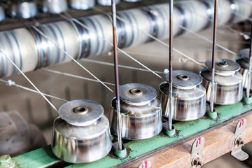 Close Up Textile Industry Yarn Spools on Spinning Machine in a Factory. Yarn spinning machine....