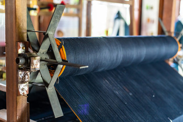 Close Up of Black Silk on the Weaving machine and Thai traditional Silk. Weaving loom for homemade...