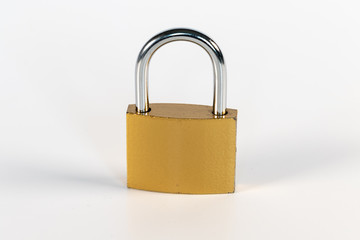 Fototapeta premium Closed golden padlock in front of white background
