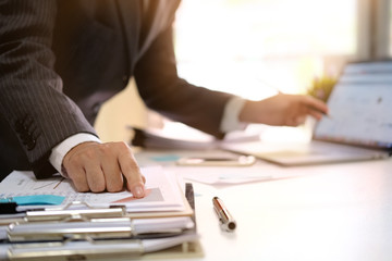 Businessman working with digital computer in modern office with virtual icon diagram at modern office in morning light