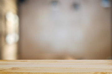 Wooden table empty and blur background for present product.
