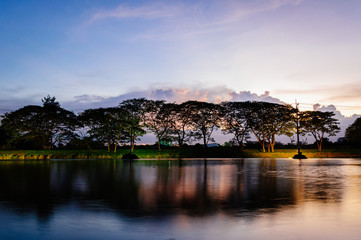 A small lake in summer , at sunset