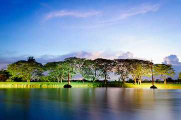 A small lake in summer , at sunset