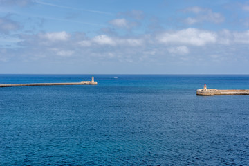Photo of Mediterranean Sea, view from Valletta, Malta. Blue cloudy sky as background.