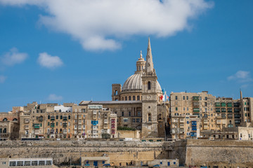 Fototapeta na wymiar photo of Valletta, Malta, skyline of capitol city with blue sky and clouds as background