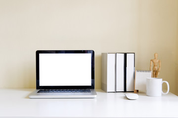 Mockup blank screen computer laptop on desk. Workspace with laptop and office supplies.