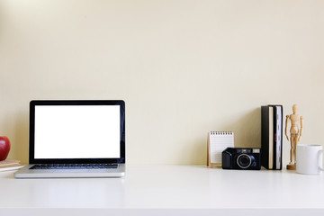 Mockup blank screen computer laptop on desk. Workspace with laptop and office supplies.