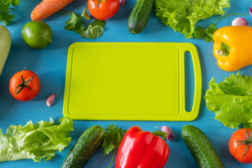 High Angle Still Life View of Knife and Wooden Cutting Board Surrounded by Fresh Herbs and...