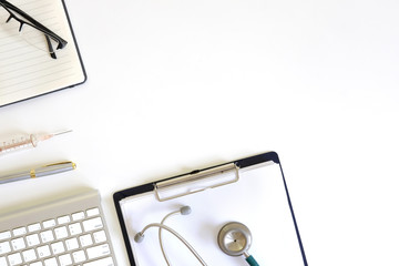 Doctor workspace with Medical equipment on white table with top view.
