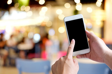 Hands holding smartphone empty display mockup mobile with cafe blur background.