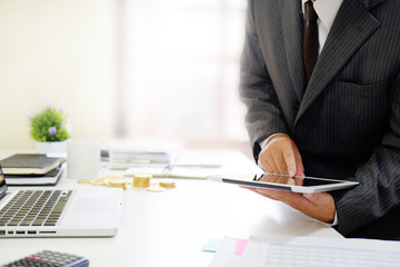 Certified public accountant, Man working on smartphone tablet computer and spreadsheet document financial data.