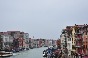 Fototapeta na wymiar Canal with gondolas in Venice. Historical old buildings above the river in Italy. European cityscape