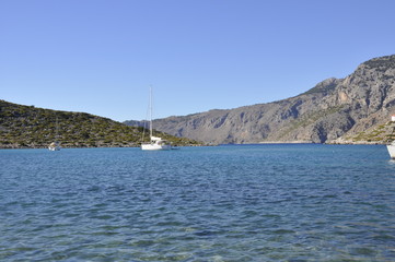 Landscape of the Greece coastline. View on the yacht in the port and the blue ocean. European...