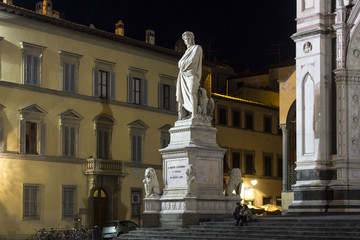 Fototapeta na wymiar Night view of Dante Alighieri statue in Florence, Italy