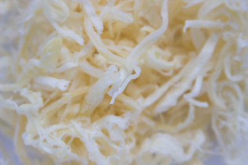 Shavings dried squid with a scattering of close-up on white background © Людмила Ильина