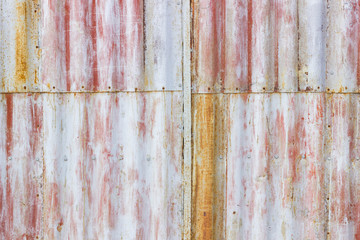 multi-colored old rusty scratched metal sheets on the wall
