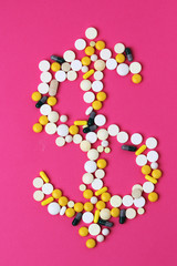 Medicine forming a sign of dollar as a concept of high cost of healthcare